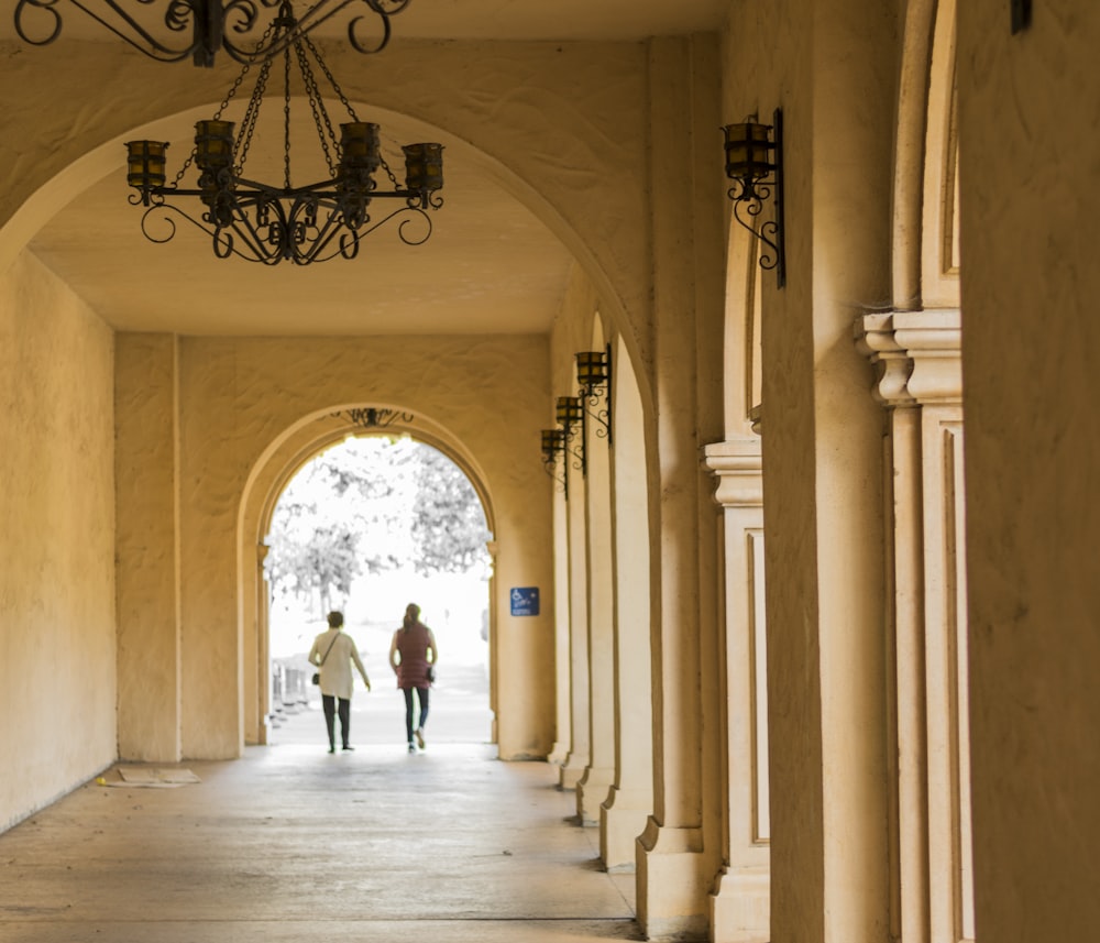 man and woman walking on hallway