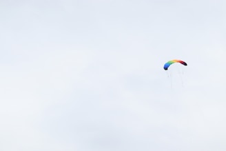 Colorful 3-meter playful parachute spread out on a classroom floor with children holding the edges.