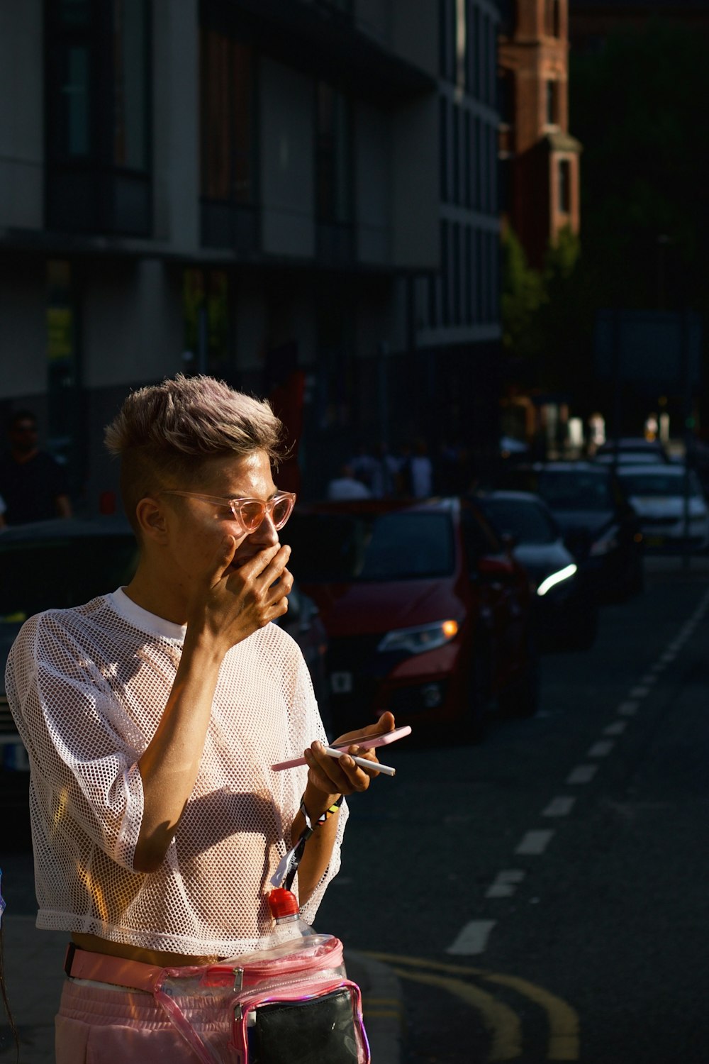 man in white and gray crew neck shirt standing on street during daytime