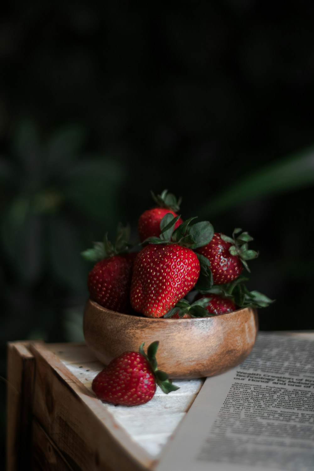 strawberries on brown wooden bowl