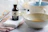Close-up of a satisfied customer holding a vanilla pod with a warm smile in a rustic kitchen setting.