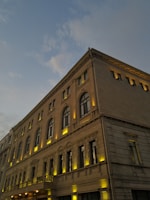 A hyper-realistic render of the elegant Altara Elite Residences entrance at dusk with warm lighting.