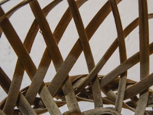 Close-up of a craftsman’s hands weaving a bamboo basket, highlighting the natural texture and intricate patterns.