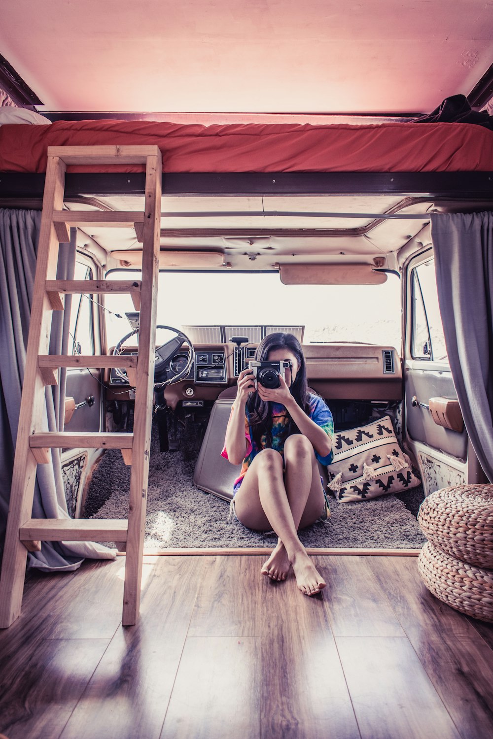 woman in black tank top sitting on brown wooden chair