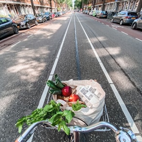 red roses in brown cardboard box on bicycle