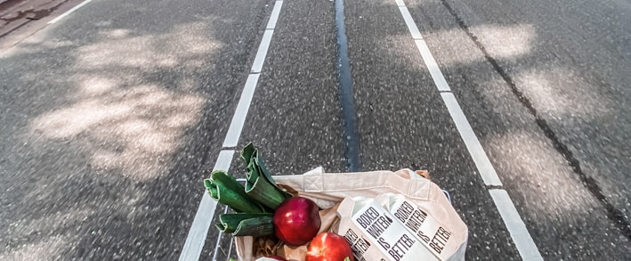 red roses in brown cardboard box on bicycle