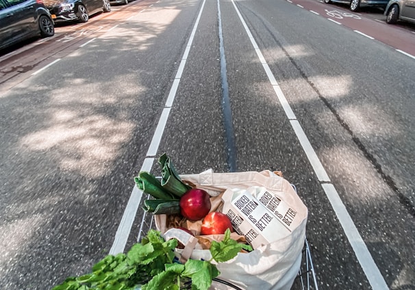 red roses in brown cardboard box on bicycle