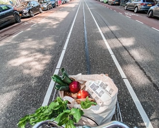 red roses in brown cardboard box on bicycle