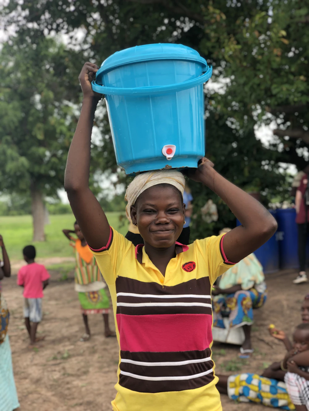 A girl carrying a bucket of water