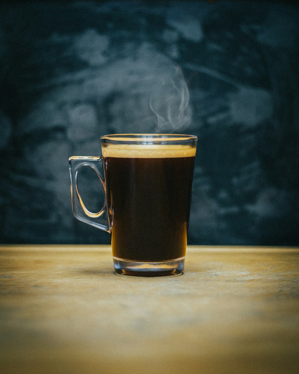 clear glass mug with brown liquid
