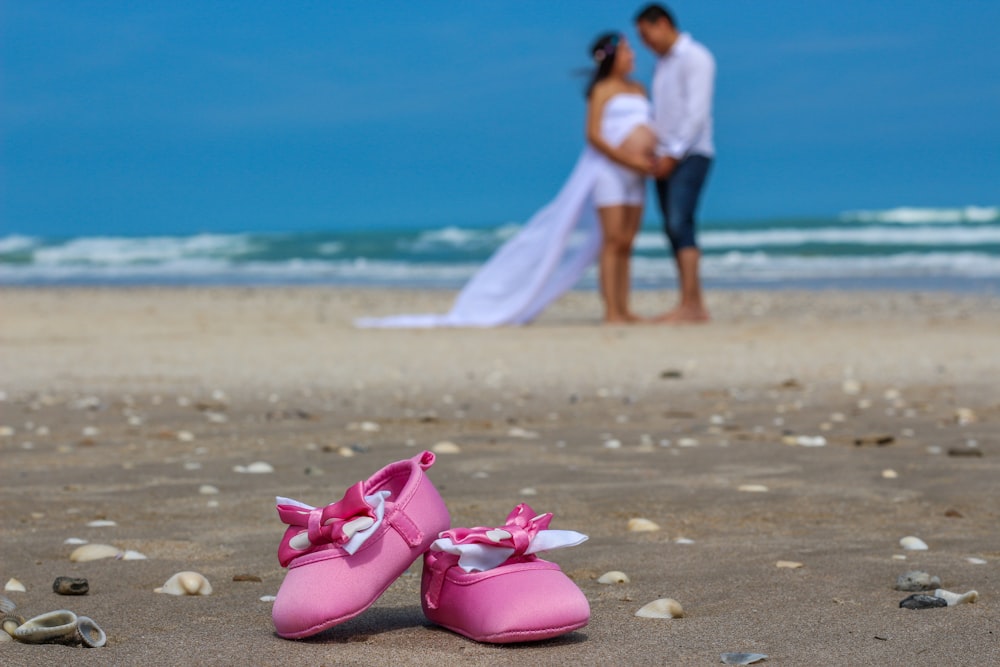 woman in white dress walking on beach during daytime