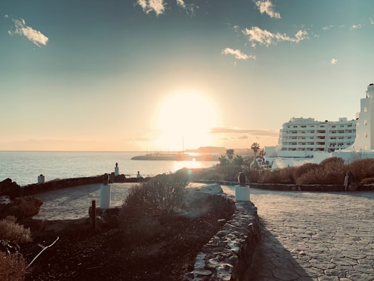 people walking on the beach during sunset in Golf del Sur Spain