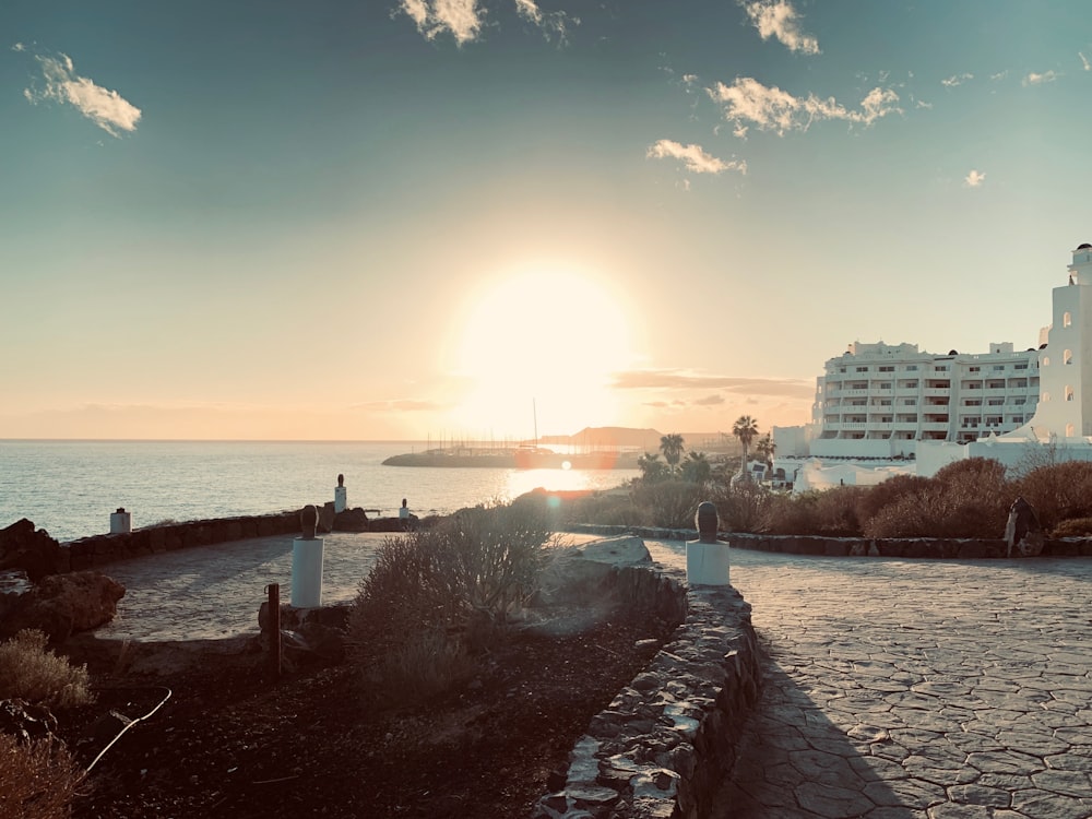 people walking on the beach during sunset