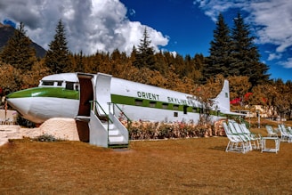 white and green plane on brown soil during daytime