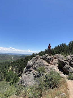 A traveler using a Podmart backpack in a scenic location.