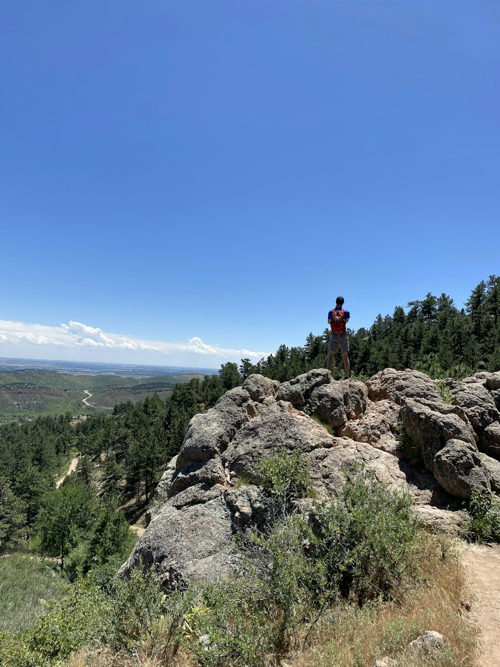 person standing on rock formation during daytime