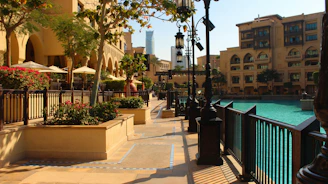 A cozy corner of the Hafen in Jois with lush Mediterranean plants and palm trees bathed in warm sunlight.