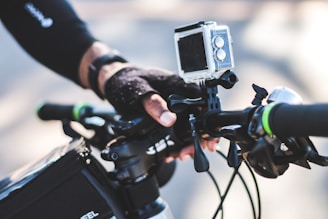 person holding black and gray camera