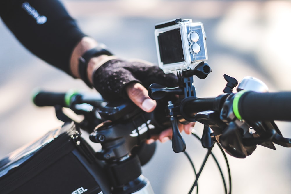 person holding black and gray camera