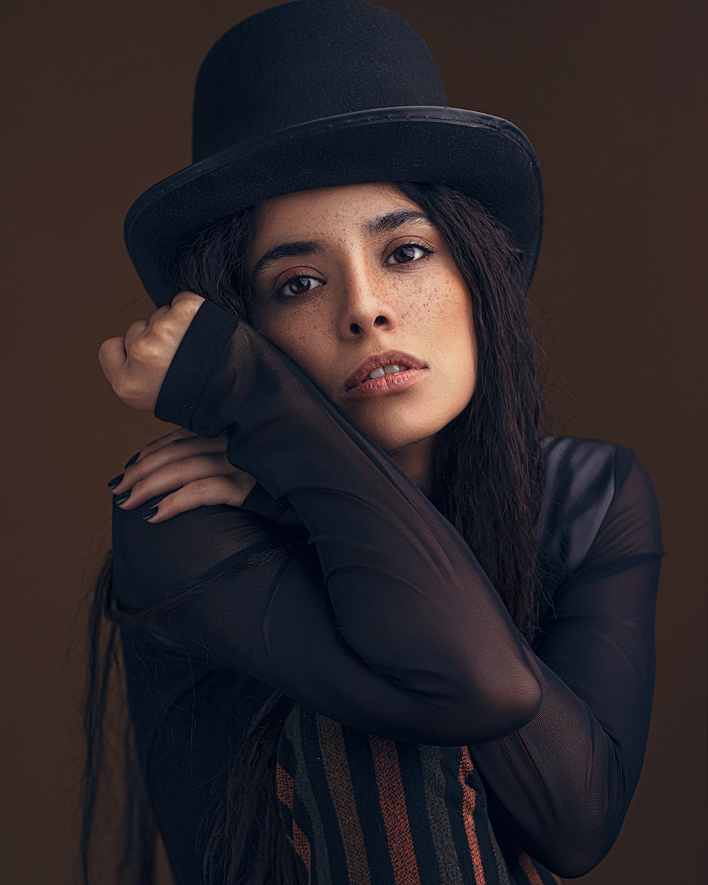 woman in black long sleeve shirt and black hat