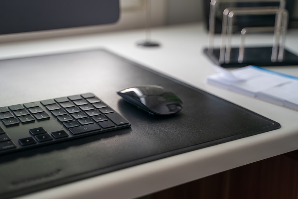 black cordless computer mouse on black mouse pad