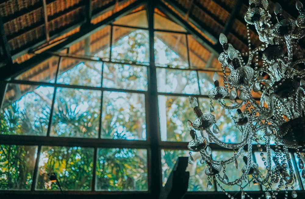 clear glass chandelier on brown wooden ceiling