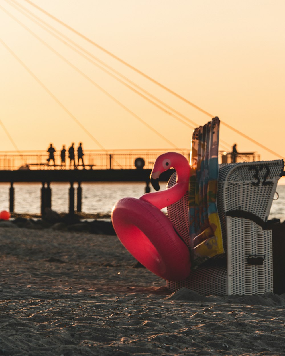 red and white polka dot chair on beach during sunset