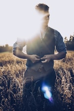 man in black and white striped dress shirt holding black smartphone