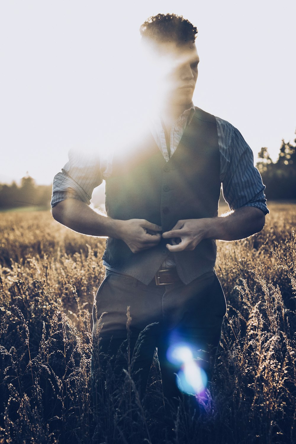 man in black and white striped dress shirt holding black smartphone