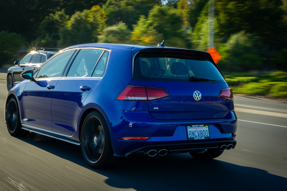 blue volkswagen golf on road during daytime