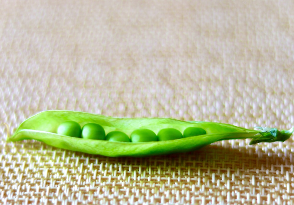 green beans on brown textile