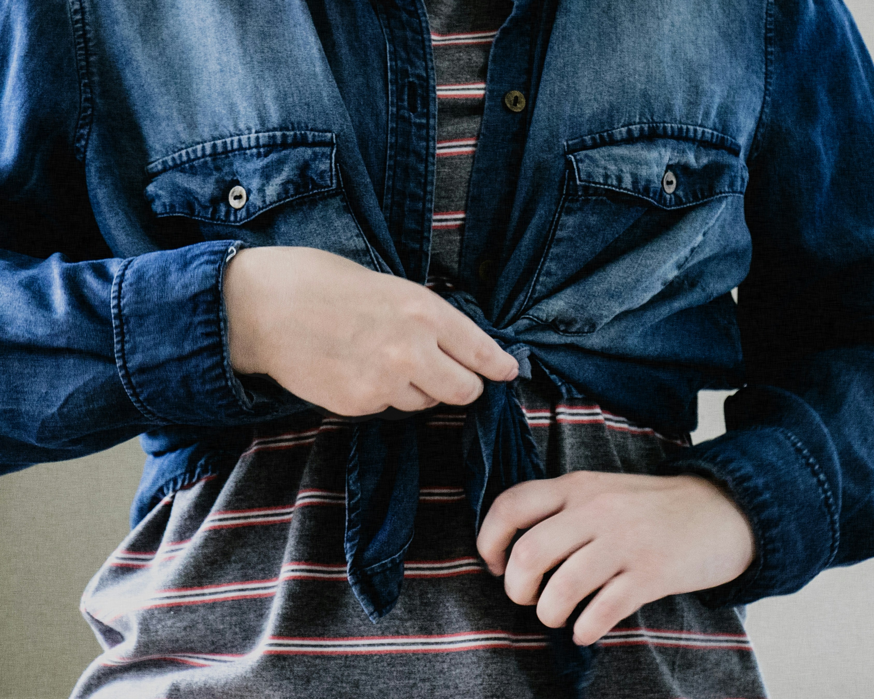How to Wear Oversized Clothing Without Looking Frumpy or Sloppy – person in blue denim button up jacket
