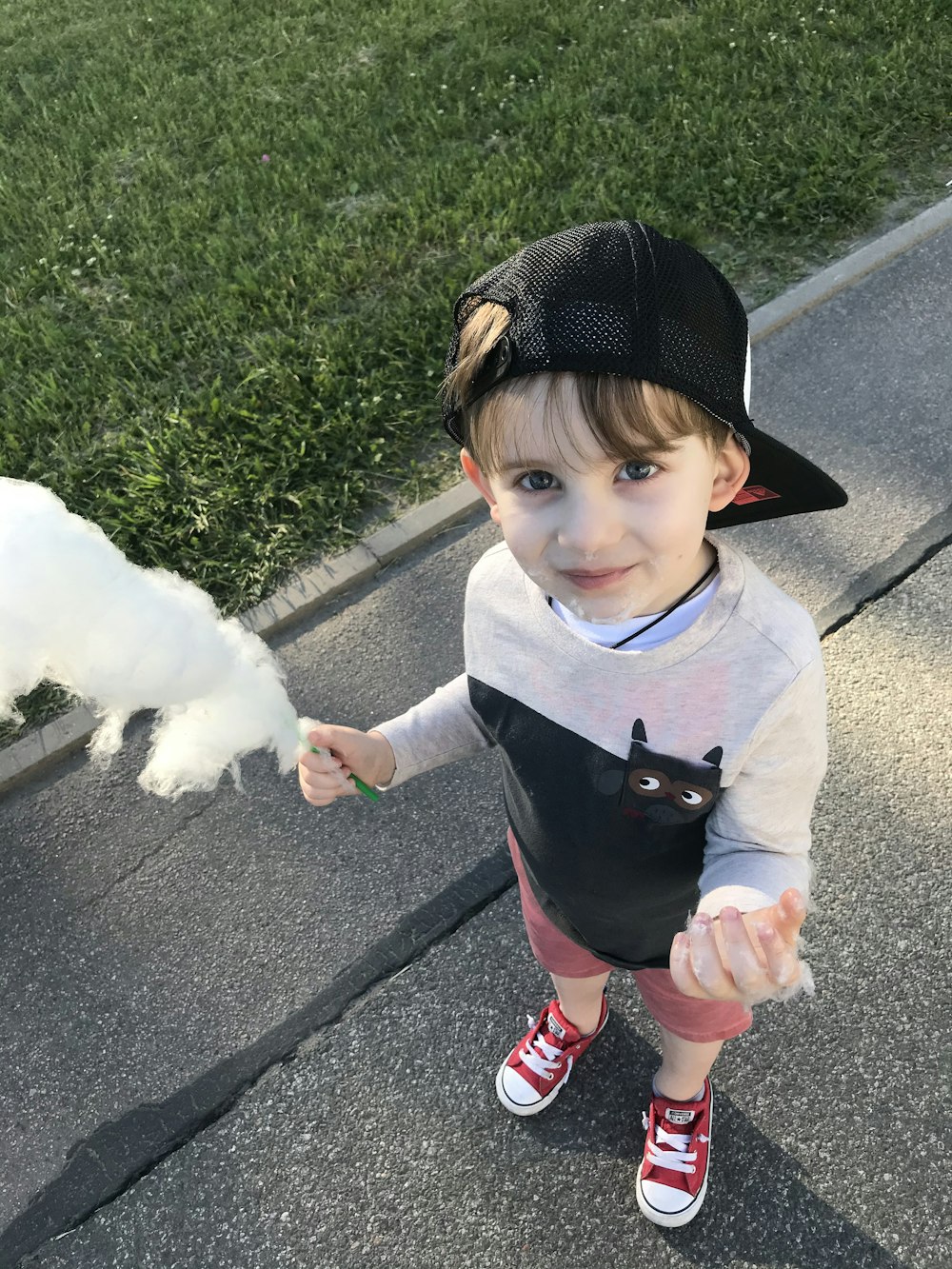 girl in black and red long sleeve shirt holding white fur animal