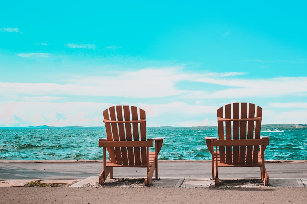 brown wooden armchair on beach during daytime