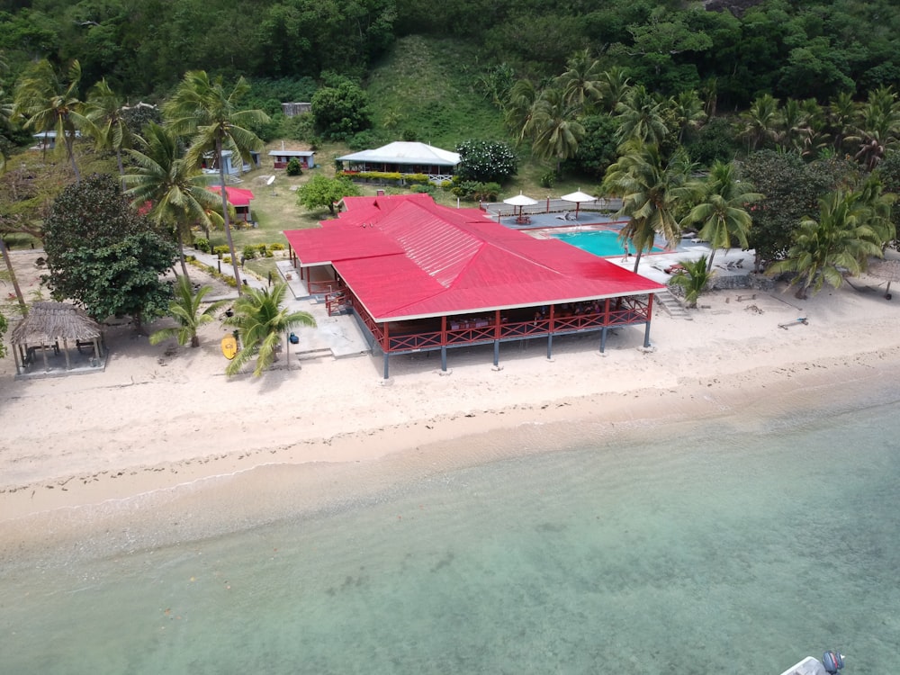 red and white wooden house on beach during daytime