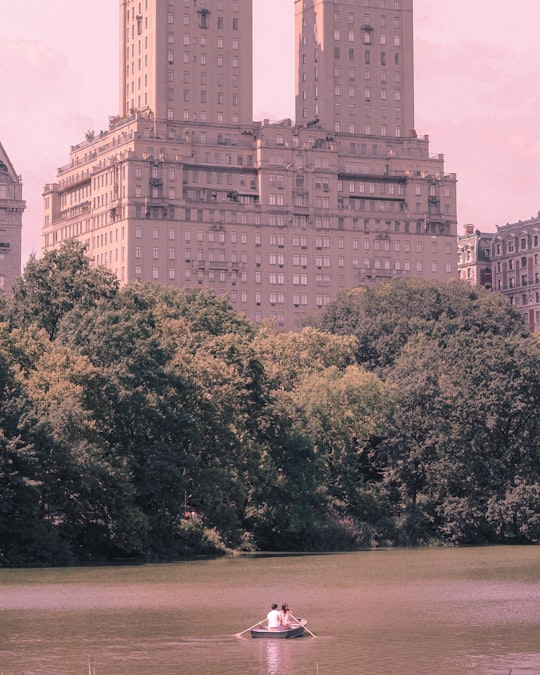 white concrete building near green trees during daytime in Central Park United States