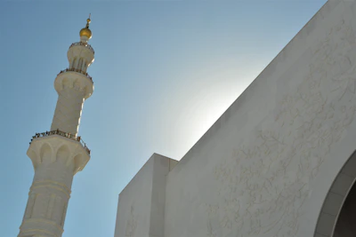Close-up of a freshly painted minaret tip shining under the sun.