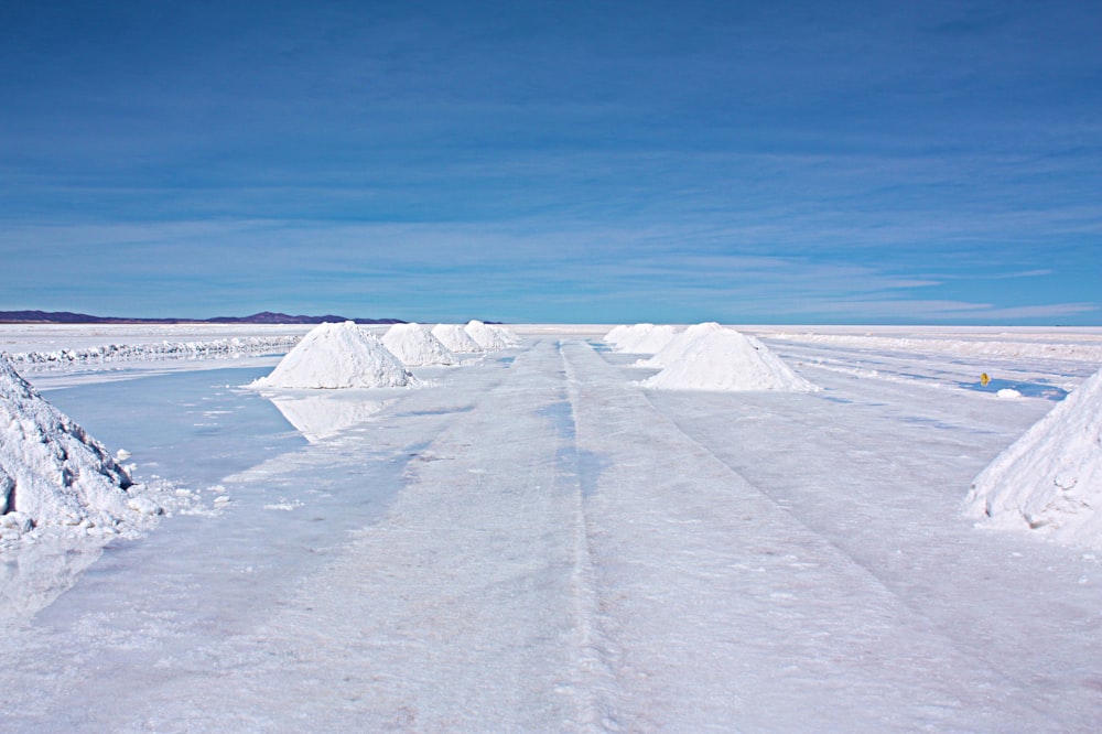 snow covered field under blue sky during daytime