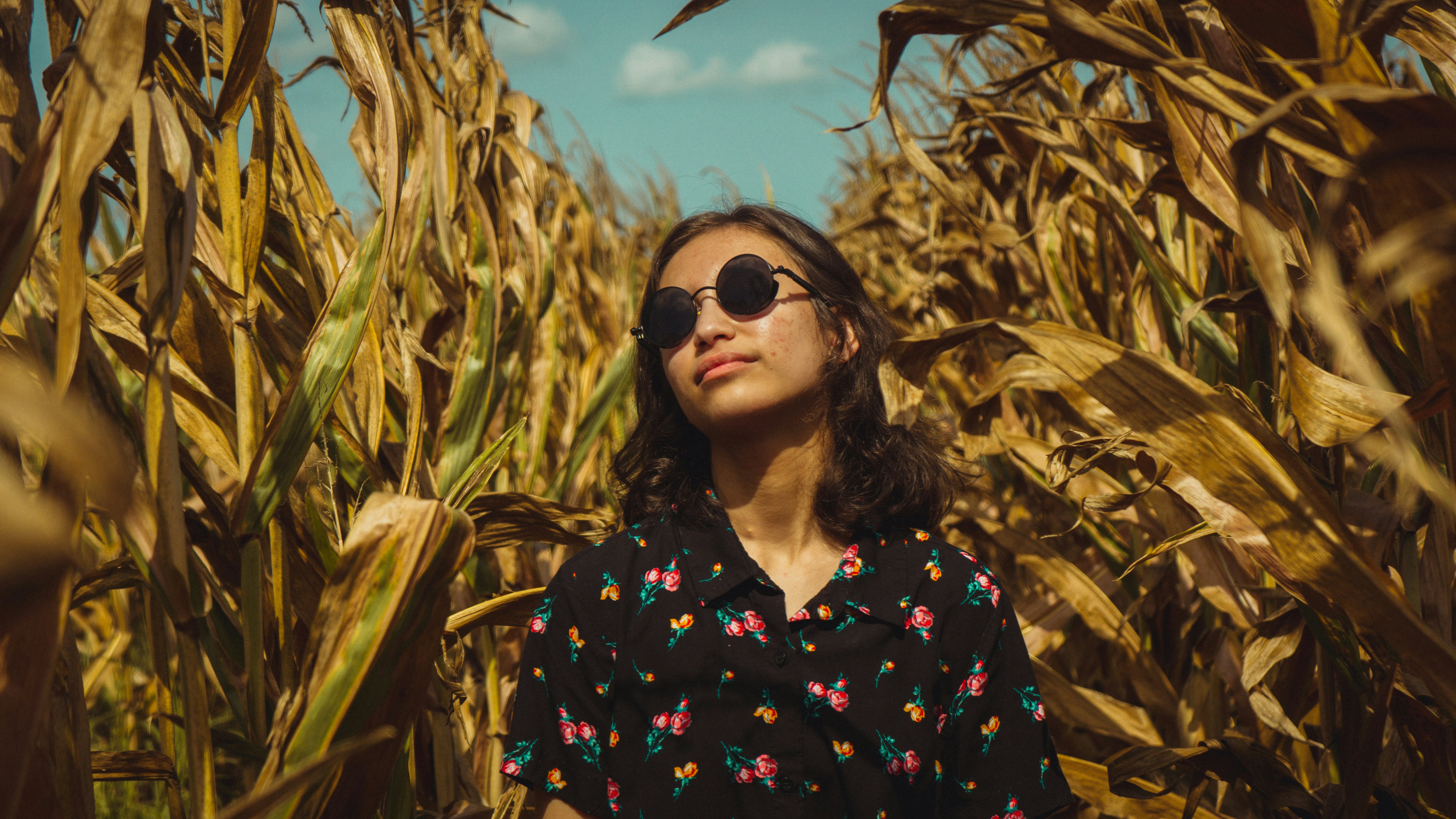 woman in black and red floral button up shirt wearing black sunglasses