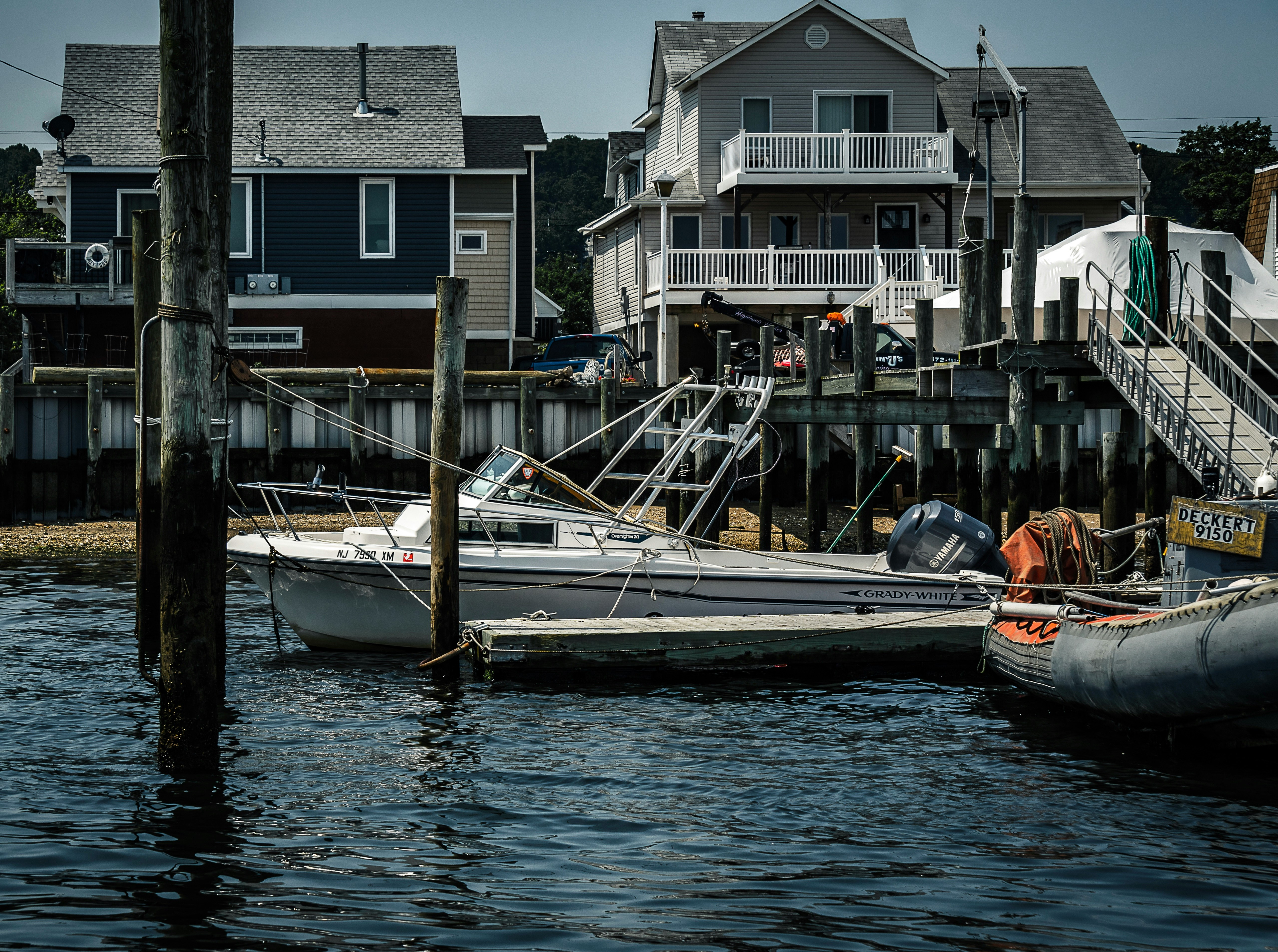 white and orange boat on dock during daytime