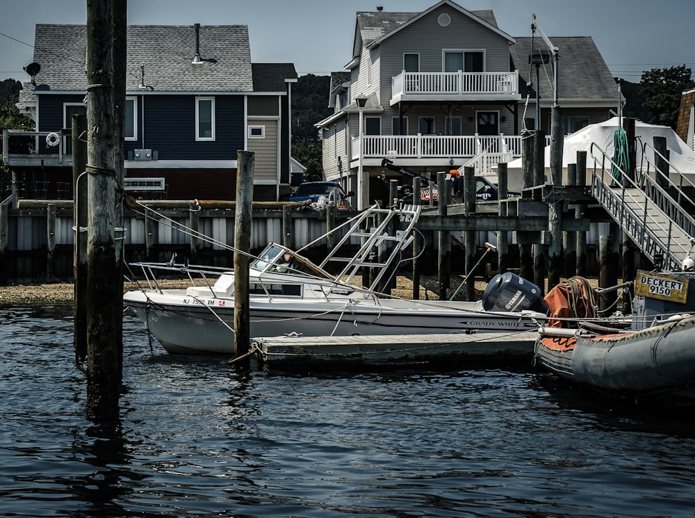 white and orange boat on dock during daytime