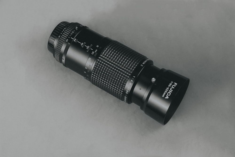 black camera lens on white table