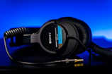 black samsung headphones on blue surface