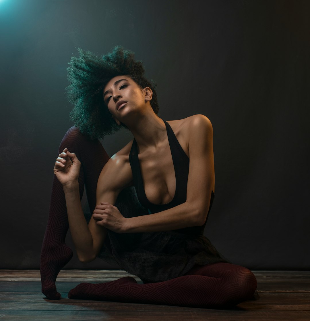 woman in black tank top sitting on floor