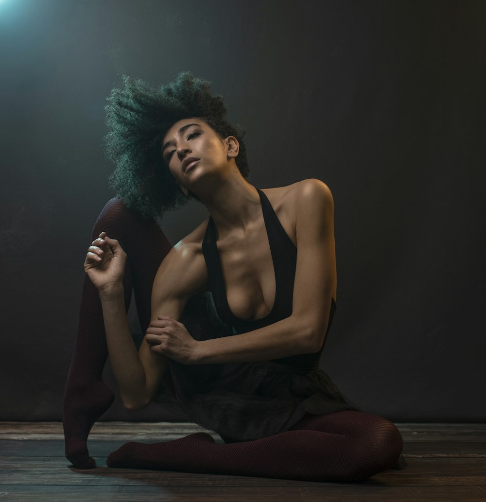 woman in black tank top sitting on floor