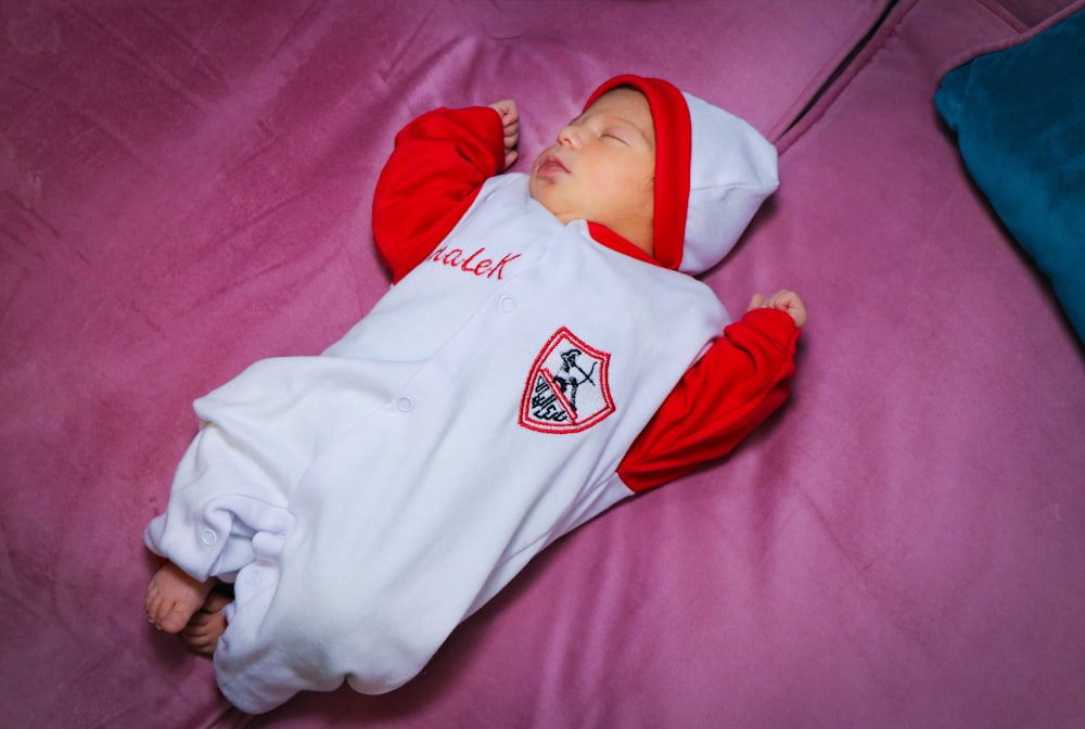 baby in white and red onesie