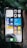A hand holding a smartphone displaying its home screen filled with various app icons, including social media, photography, and utility apps. The background shows a few leaves, adding a natural element to the scene. The time is shown as 5:08, and the date is set to Monday the 6th. Widgets present include a weather forecast for Ottawa, currently showing a temperature of 31°C with mostly sunny conditions.