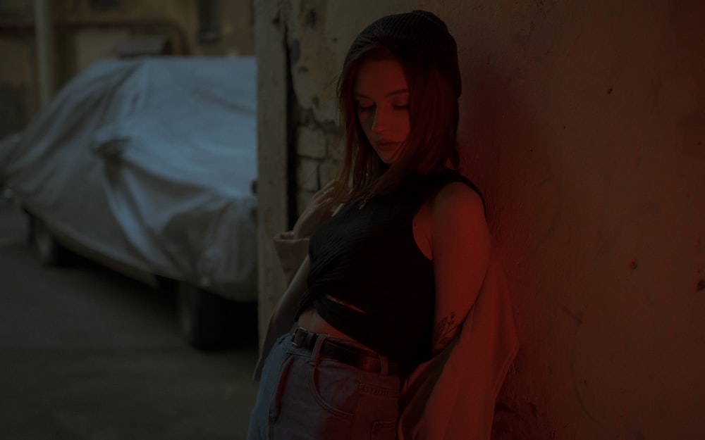 woman in black tank top and blue denim jeans