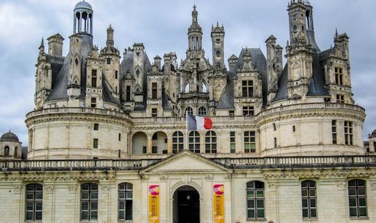 gray concrete building under cloudy sky during daytime in Château de Chambord France