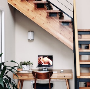 black flat screen tv turned on near brown wooden table